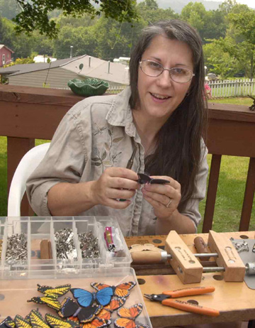 Mindy King works on a butterfly